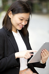 Image showing Young Asian female business executive using tablet