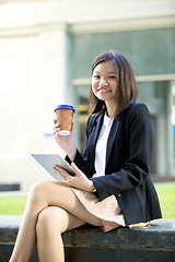 Image showing Young Asian female business executive using tablet