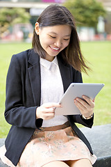 Image showing Young Asian female business executive using tablet