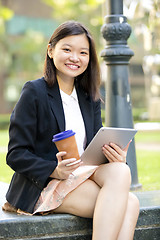 Image showing Young Asian female business executive using tablet