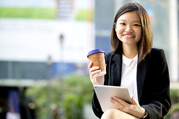 Image showing Young Asian female business executive using tablet