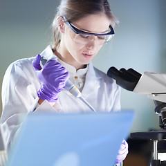 Image showing Portrait of a helth care professional microscoping.