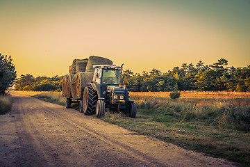 Image showing Old tractor with hay bales