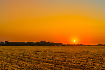 Image showing Sunrise over a countryside field