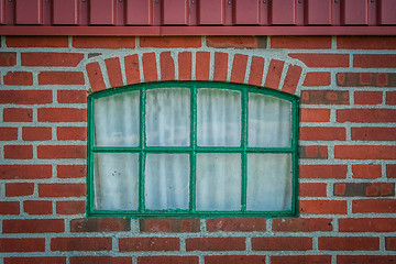 Image showing Green window on a brick wall