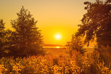 Image showing Sunrise over a lake with trees