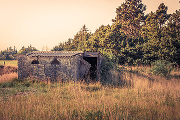 Image showing Small brick house on a field