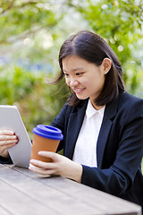 Image showing Young Asian female business executive using tablet