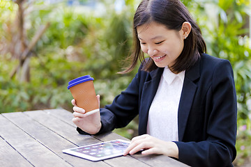 Image showing Young Asian female business executive using tablet