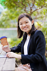 Image showing Young Asian female business executive using tablet