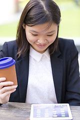 Image showing Young Asian female business executive using tablet