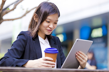 Image showing Young Asian female business executive using tablet