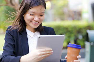 Image showing Young Asian female business executive using tablet