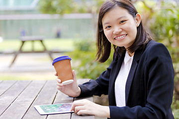 Image showing Young Asian female business executive using tablet