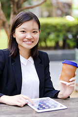 Image showing Young Asian female business executive using tablet