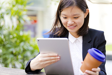 Image showing Young Asian female business executive using tablet