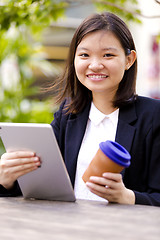 Image showing Young Asian female business executive using tablet