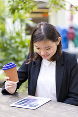 Image showing Young Asian female business executive using tablet