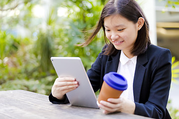 Image showing Young Asian female business executive using tablet