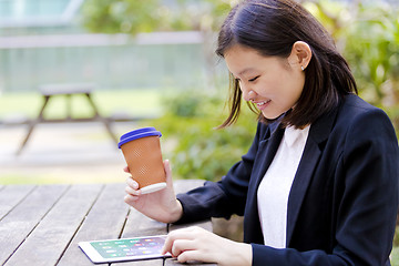 Image showing Young Asian female business executive using tablet