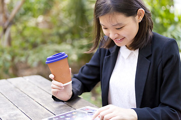 Image showing Young Asian female business executive using tablet