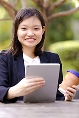 Image showing Young Asian female business executive using tablet