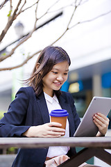 Image showing Young Asian female business executive using tablet