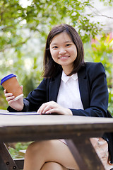 Image showing Young Asian female business executive using tablet