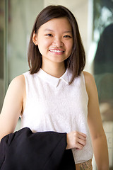 Image showing Young Asian female business executive smiling portrait