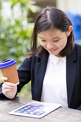 Image showing Young Asian female business executive using tablet