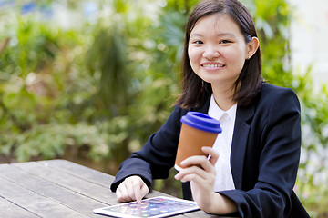 Image showing Young Asian female business executive using tablet