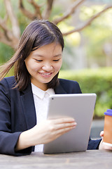 Image showing Young Asian female business executive using tablet