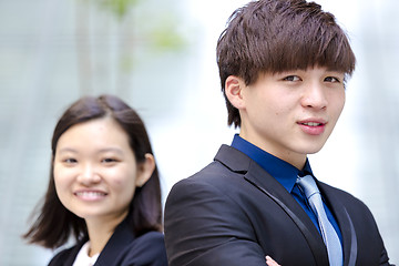 Image showing Young Asian female and male business executive smiling portrait