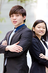 Image showing Young Asian female and male business executive smiling portrait