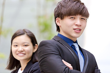 Image showing Young Asian female and male business executive smiling portrait