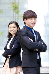 Image showing Young Asian female and male business executive smiling portrait