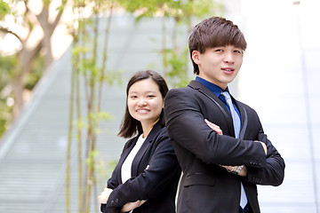 Image showing Young Asian female and male business executive smiling portrait