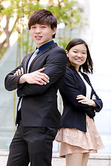 Image showing Young Asian female and male business executive smiling portrait