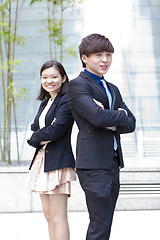 Image showing Young Asian female and male business executive smiling portrait