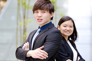 Image showing Young Asian female and male business executive smiling portrait