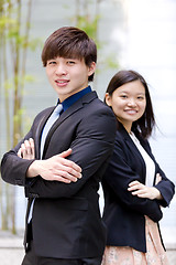 Image showing Young Asian female and male business executive smiling portrait