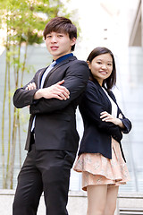 Image showing Young Asian female and male business executive smiling portrait