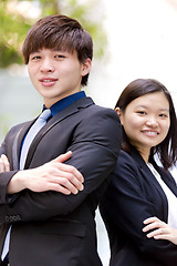 Image showing Young Asian female and male business executive smiling portrait