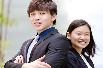 Image showing Young Asian female and male business executive smiling portrait