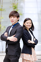 Image showing Young Asian female and male business executive smiling portrait