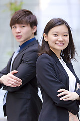 Image showing Young Asian female and male business executive smiling portrait