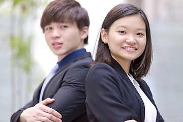 Image showing Young Asian female and male business executive smiling portrait