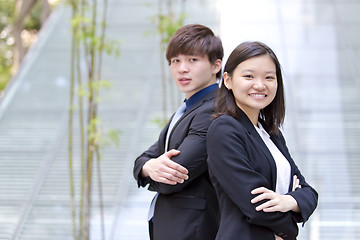 Image showing Young Asian female and male business executive smiling portrait