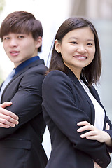 Image showing Young Asian female and male business executive smiling portrait