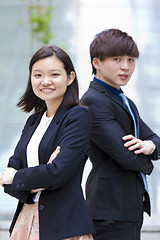 Image showing Young Asian female and male business executive smiling portrait